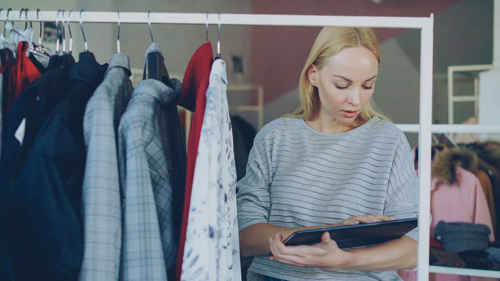 A store owner checking inventory on a tablet