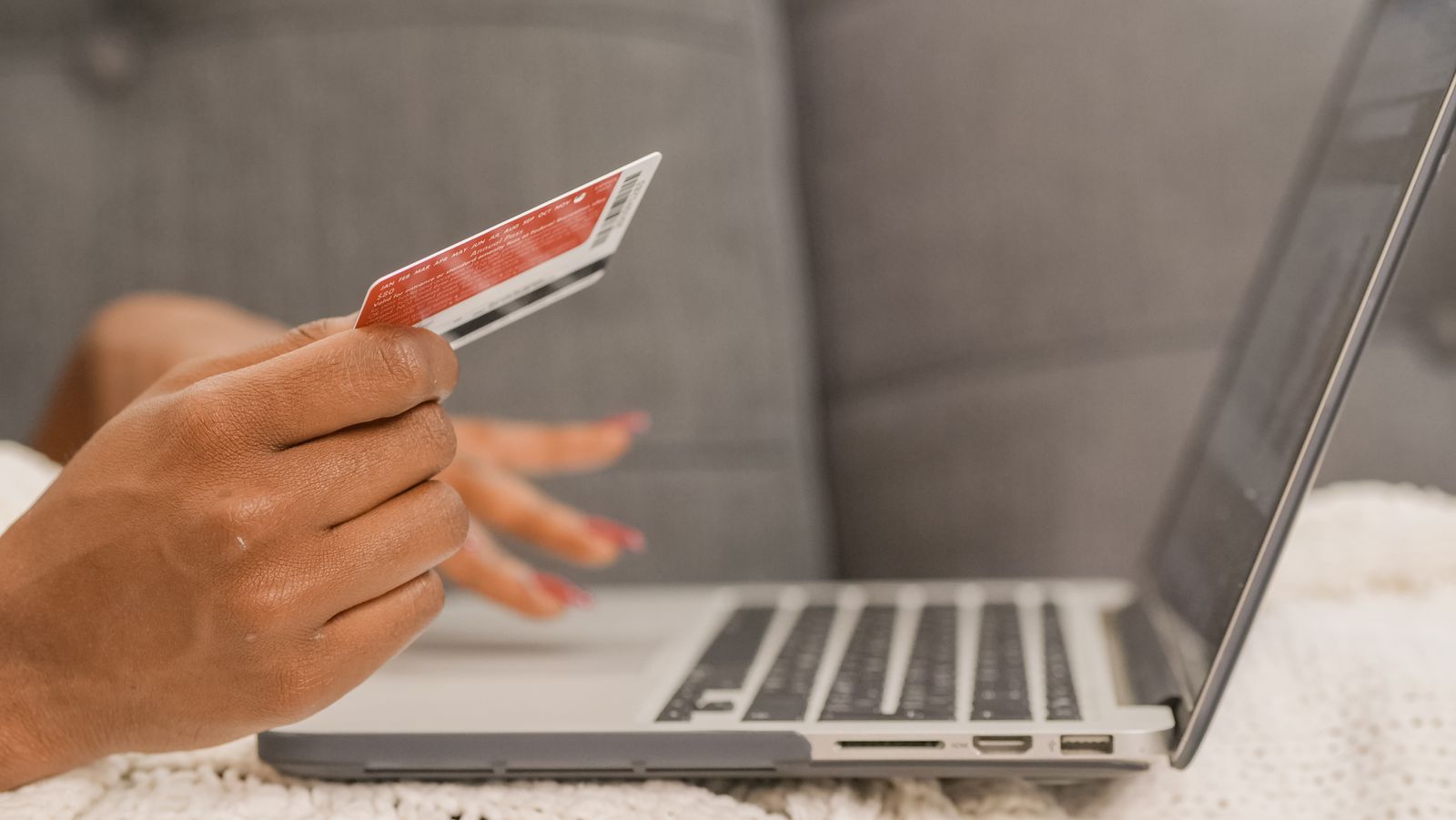 A customer paying by card on their laptop