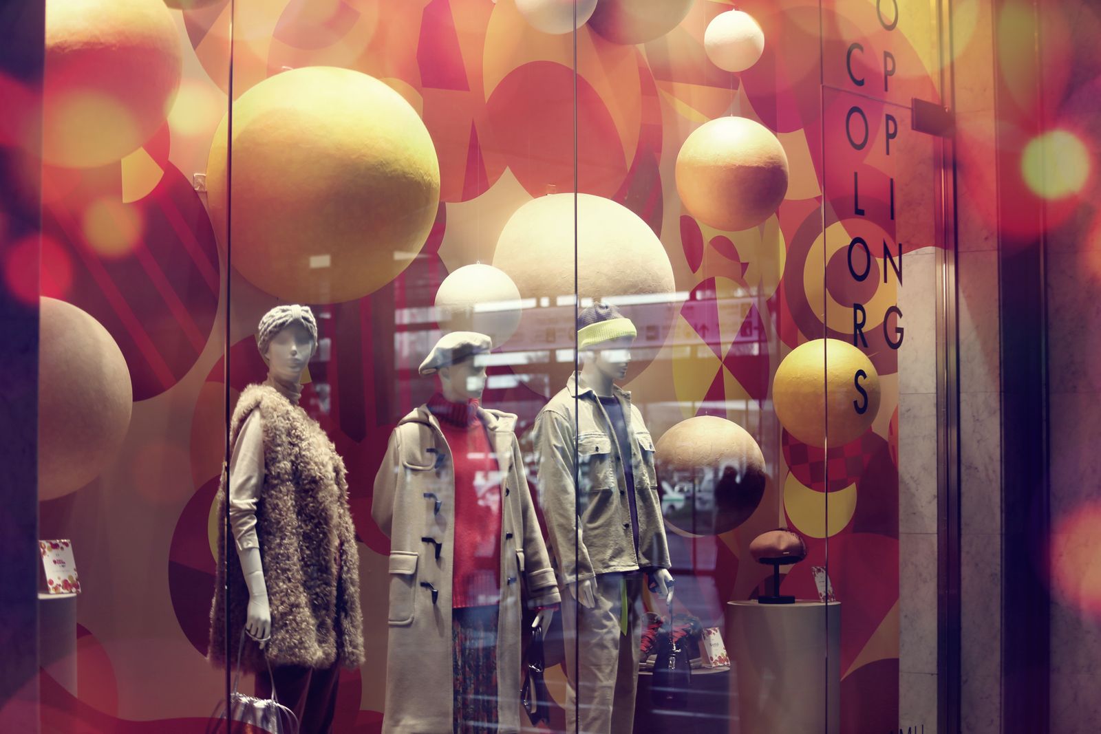 A vibrant shop window display with dressed mannequins